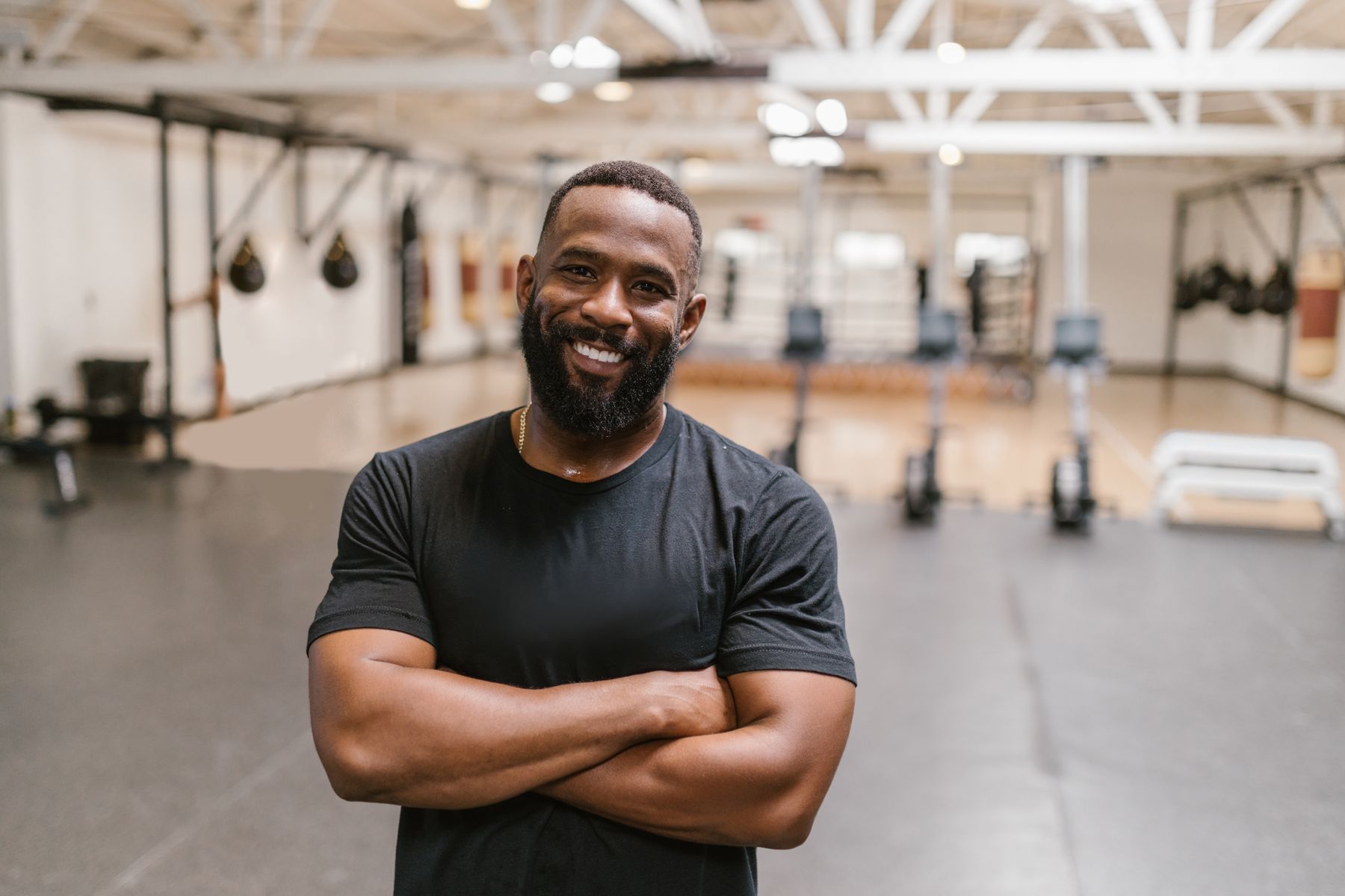 Fitness facility leader standing confidently on a professional gym floor